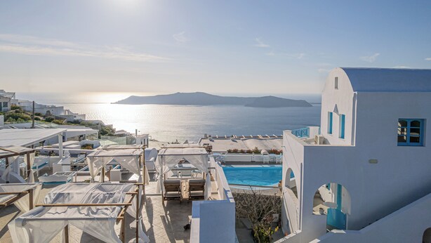 A coastal hotel with a pool, outdoor seating, and a view of the sea. - Salvatore Caldera Suites (Santorini)