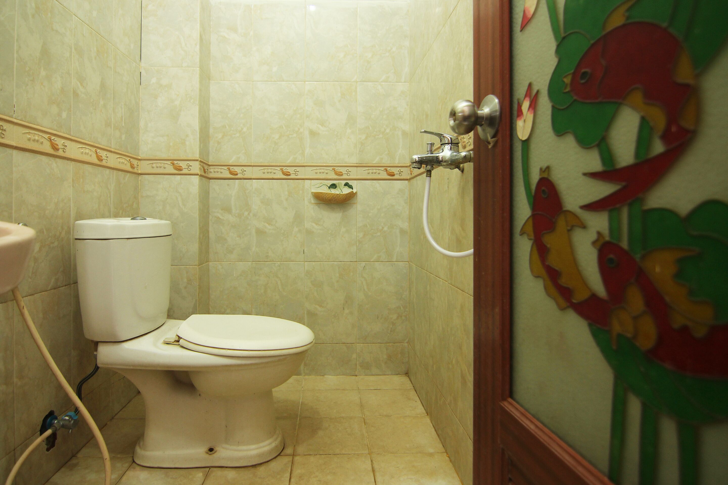 A bathroom with a toilet, a sink, and a shower.