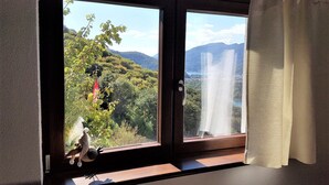 A room with a large window overlooking a mountainous landscape. - Home near Franklin College and Lugano Center (Collina d'Oro)