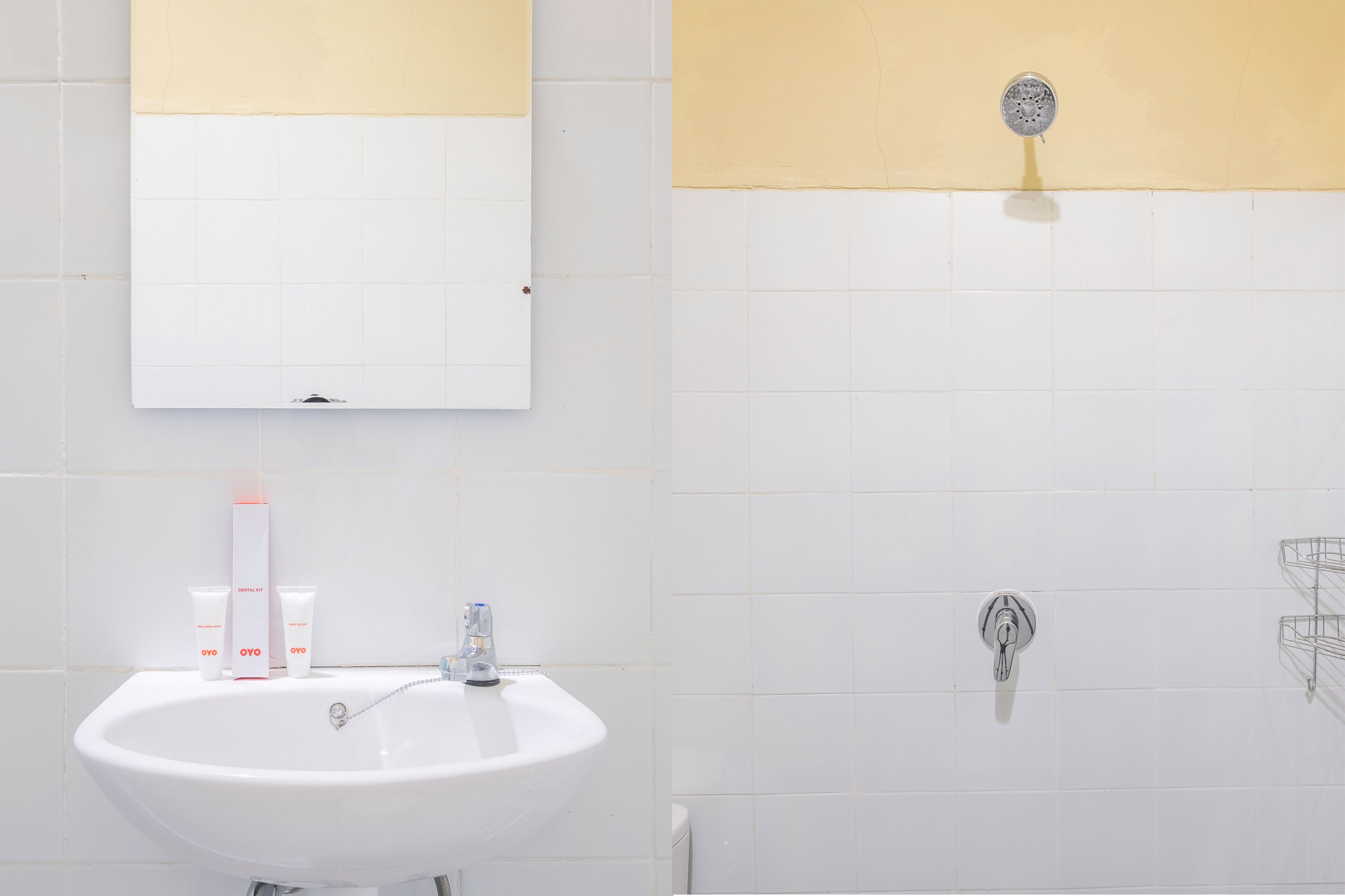 A bathroom with a white sink, mirror, and tiled walls.