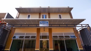 A modern building with a signboard indicating it is a hotel.