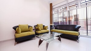 A modern living room with two sofas and a glass coffee table.