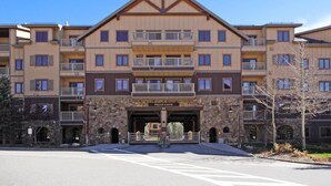 A multi-story hotel with a stone facade, balconies, and a central entrance labeled "Red Hawk."