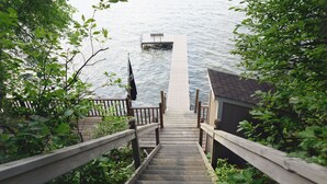 A wooden staircase leading to a dock over water, surrounded by greenery. - Lakeside Leisure: Relax, Recharge, Reconnect! (Alexandria)