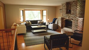 A living room with a sofa, coffee table, and fireplace. - Lakeside Leisure: Relax, Recharge, Reconnect! (Alexandria)