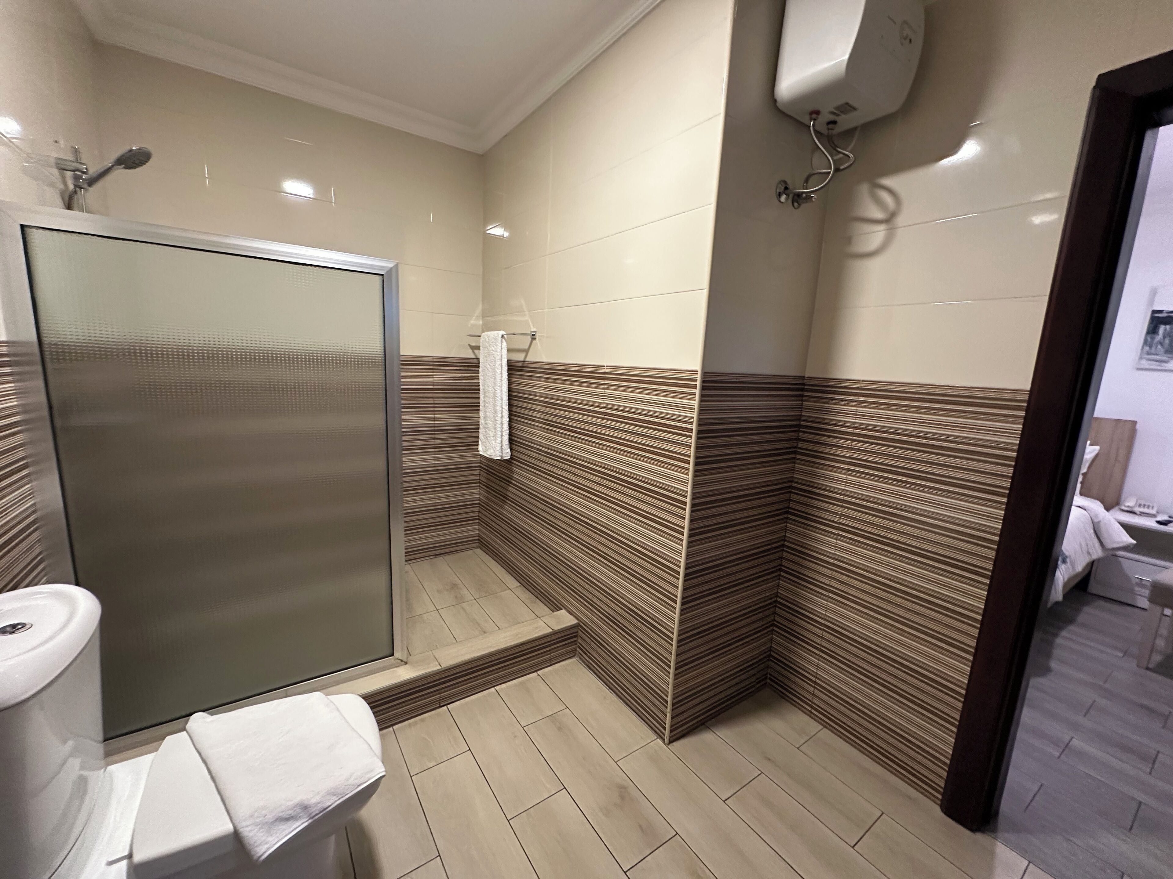 Standard Room, 1 Queen Bed, Refrigerator, Garden Area | Bathroom | Shower, rainfall showerhead, free toiletries, towels