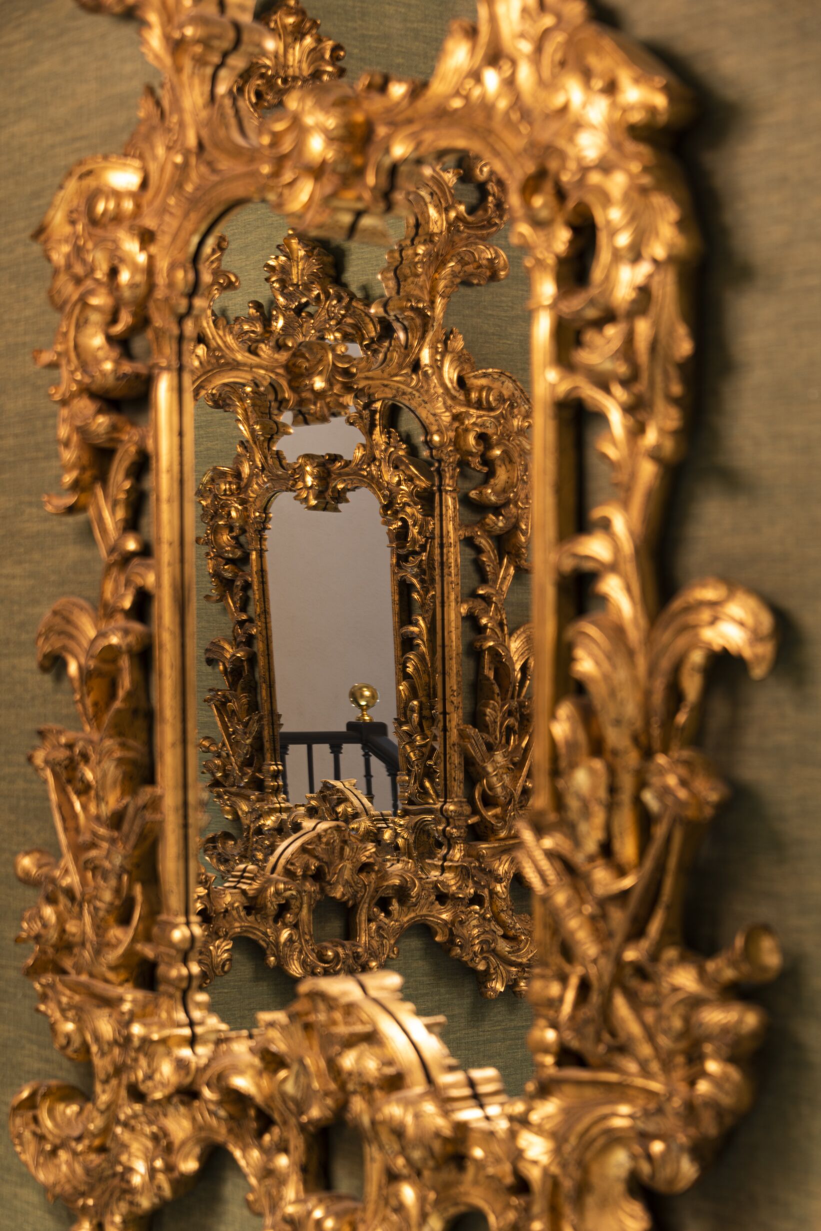 An ornate gold-framed mirror with intricate designs.