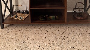 A flat-screen TV on a wooden entertainment center with shelves below. - STEPS TO GULF BEACH! (Holmes Beach)