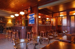 Enjoy a welcoming space to socialize and relax at the bar, featuring a selection of beverages and comfortable seating.