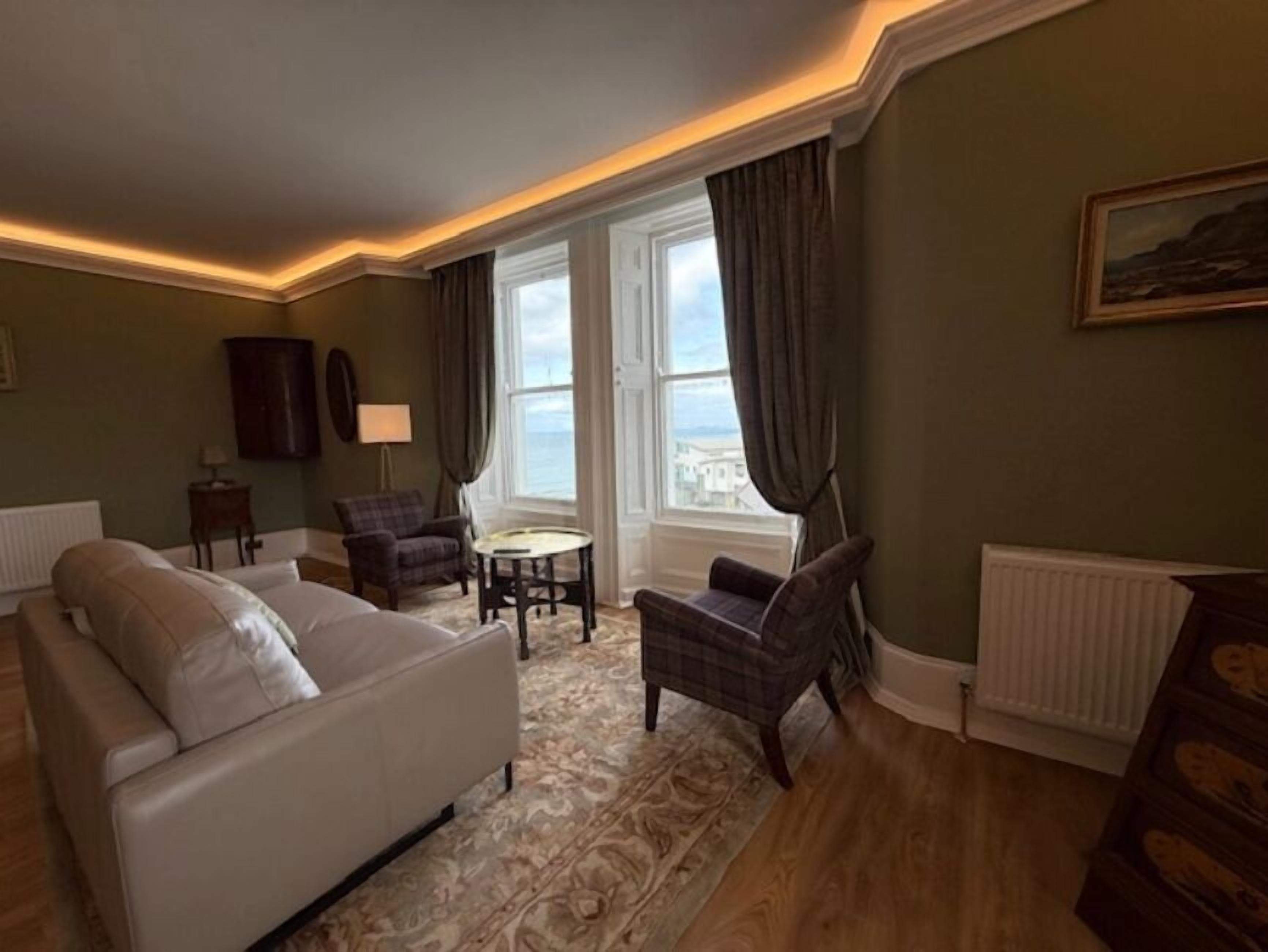 Luxury Suite | Living area | 55-inch TV with digital channels