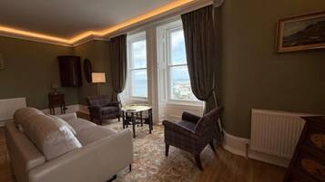 Luxury Suite | Living area | 55-inch TV with digital channels