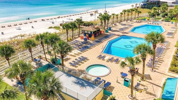A resort with a beach, two swimming pools, and a bar area. - The Summit 621 (Panama City Beach)