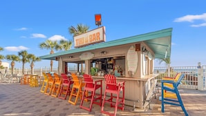 Eine Tiki-Bar mit Außenbestuhlung und Meerblick.