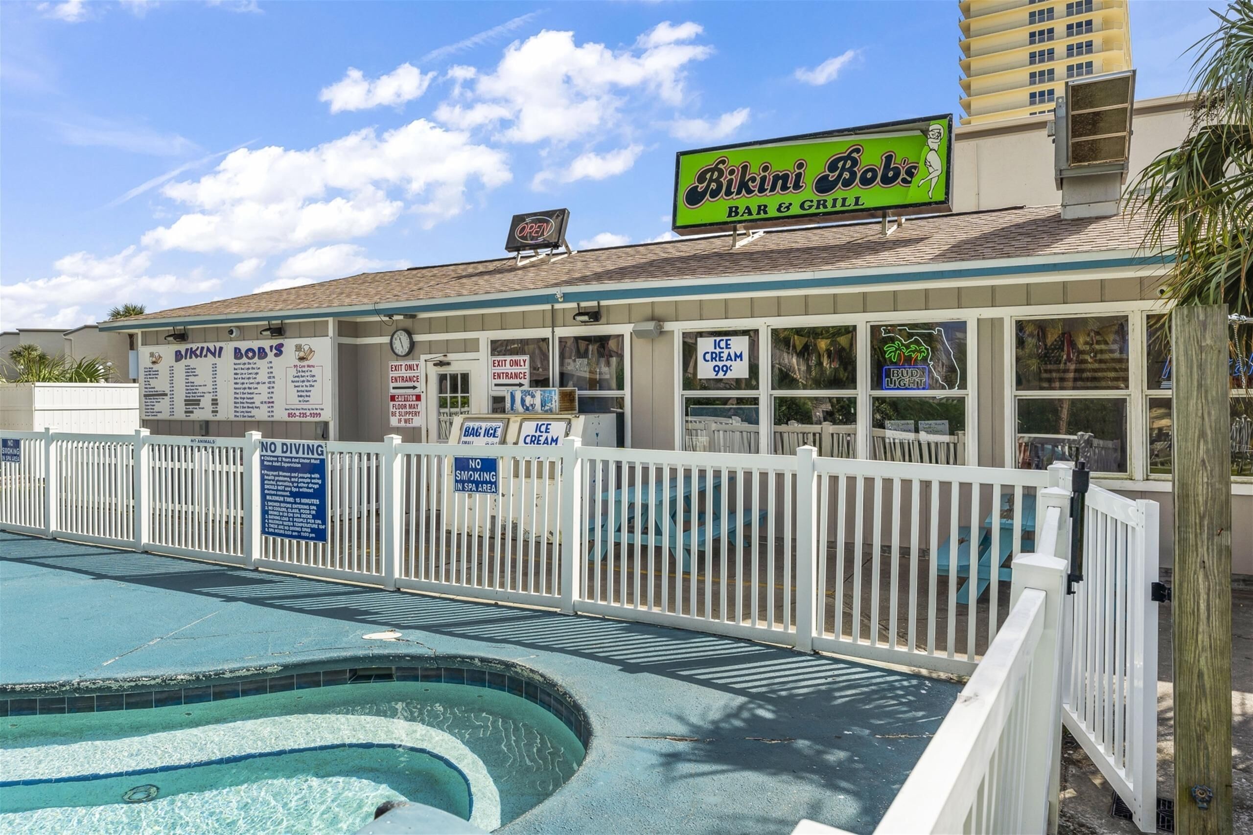 A pool area with a sign for Bikini Bob's Bar & Grill.