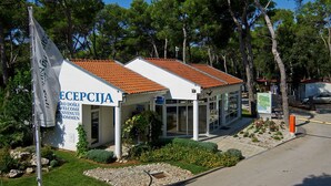 A building with a tiled roof and a sign reading "RECEPTION".