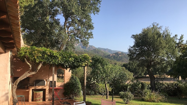 Ein Patio mit Sitzgelegenheiten, einem Tisch und einem Grill.