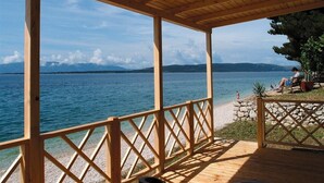 A wooden deck with a view of a lake and mountains. - Victoria Mobilehome Camping Dole (Podgora)