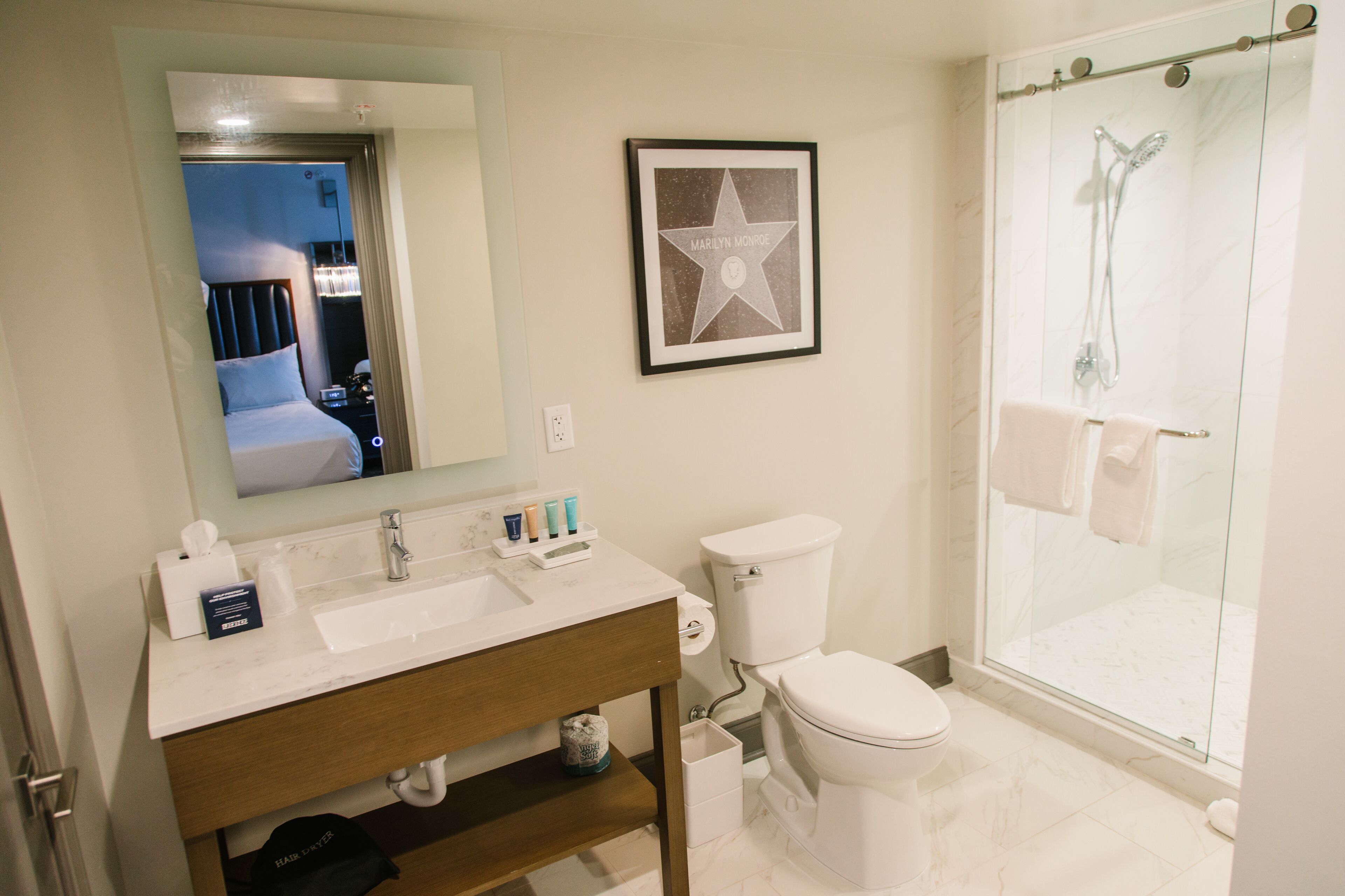 A bathroom with a sink, toilet, and glass-enclosed shower.