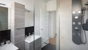 A modern bathroom with a glass shower enclosure, a white sink, and a mirror. - Le Hauban - Three Bedroom Apartment, Sleeps 6 (Saint-Malo)
