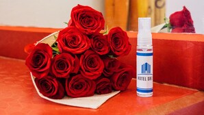 A bouquet of red roses and a bottle of Hotel SRS disinfectant. - Hotel SR92 Only Adults (Mexico City)