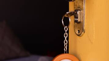 A door with a metal handle and a keychain with a label.