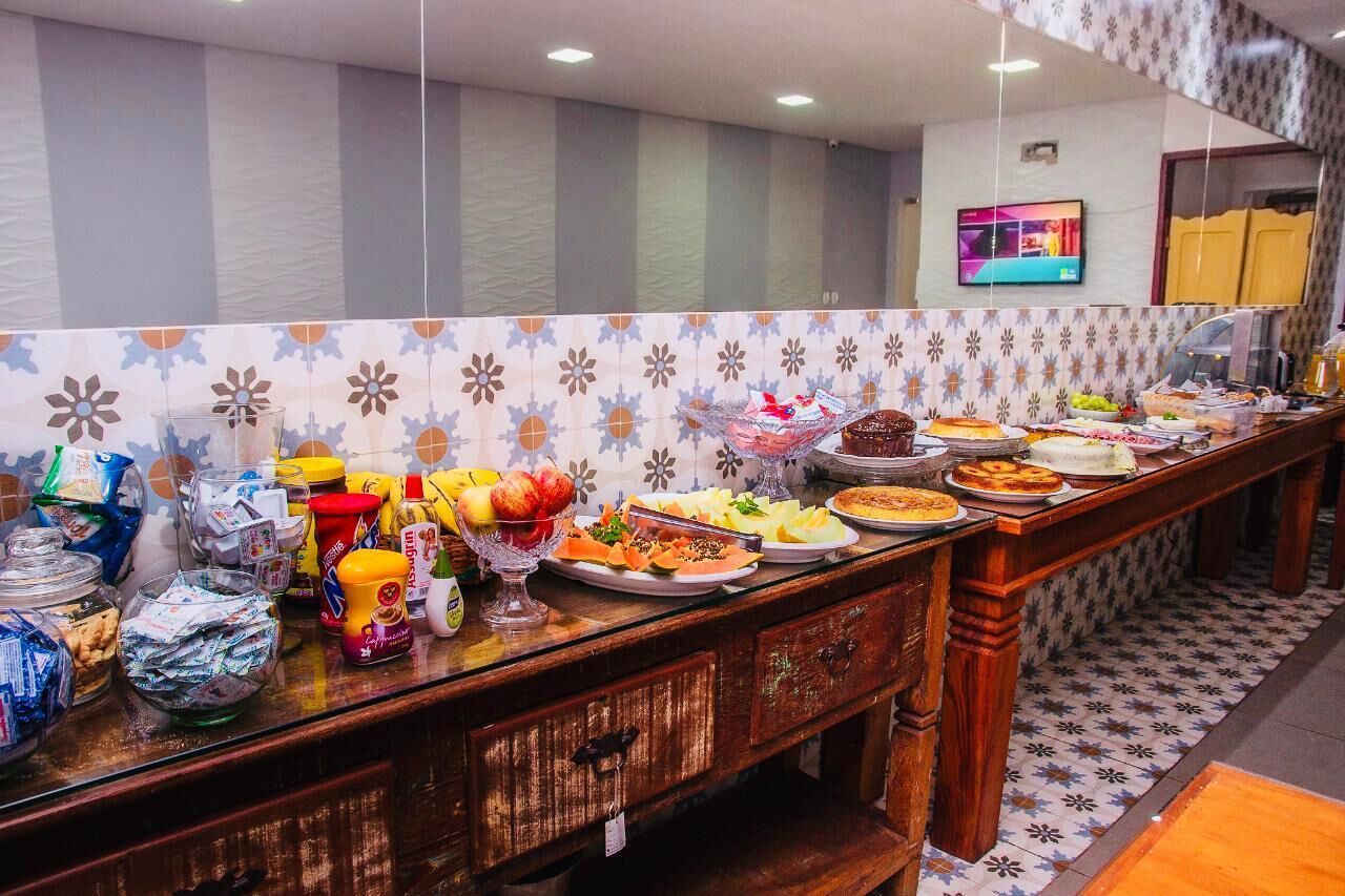 A buffet setup with various food items and condiments.