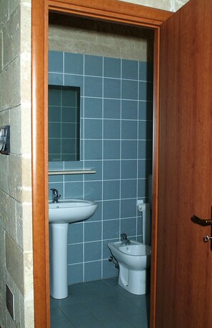A bathroom with a sink, bidet, and mirror. - Tenuta Santrifone (Secli)