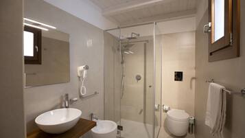 A modern bathroom with a glass-enclosed shower, two sinks, and a large mirror.