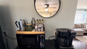 A kitchenette with a microwave, coffee maker, and a hanging mirror. - Breezy Pad, Close to the Lake, with Hot Tub (St Joseph)