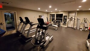 A gym with treadmills, weight machines, and a rack of dumbbells. - ❤ Lovely condo! Walking distance to Strip with pool & spa (Las Vegas)