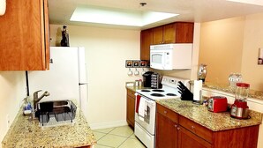 A compact kitchen with a refrigerator, stove, microwave, and a coffee maker. - ❤ Lovely condo! Walking distance to Strip with pool & spa (Las Vegas)