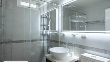 Combined shower/bathtub, hair dryer, slippers, towels