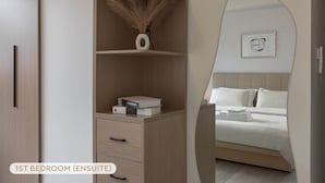 A 1st bedroom with a wooden wardrobe, a bedside table with a lamp, and a bed with white linens. - 2 min to MRT, 4B2b Shopping/Restaurant District (Taipei)