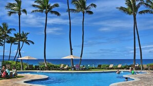 A pool area with palm trees, lounge chairs, and umbrellas. - Wailea Ekahi 34A Spacious Wailea 1BR w AC Pool Near Beach (Kihei)