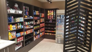 A well-organized pantry with shelves stocked with various food items and beverages. - Simple Suites Boise Airport (Boise)