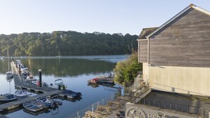 A waterfront property with a dock, boats, and a coffee shop named "Heron Farm & Coffee Shop". - This holiday home is situated right on the water’s edge within the Malpas Marina (Malpas)