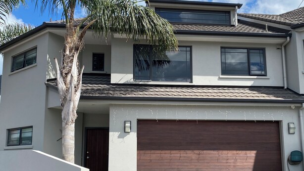 A two-story house with a garage, a palm tree, and a mailbox. - Apartment Ahuriri short stroll to beach.<br> (Ahuriri)