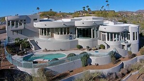 A modern, multi-story house with a swimming pool, multiple balconies, and a landscaped garden. - Golfers Paradise in Fountain Hills (Fountain Hills)