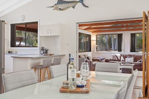 A modern interior with a dining area, kitchen, and living space.