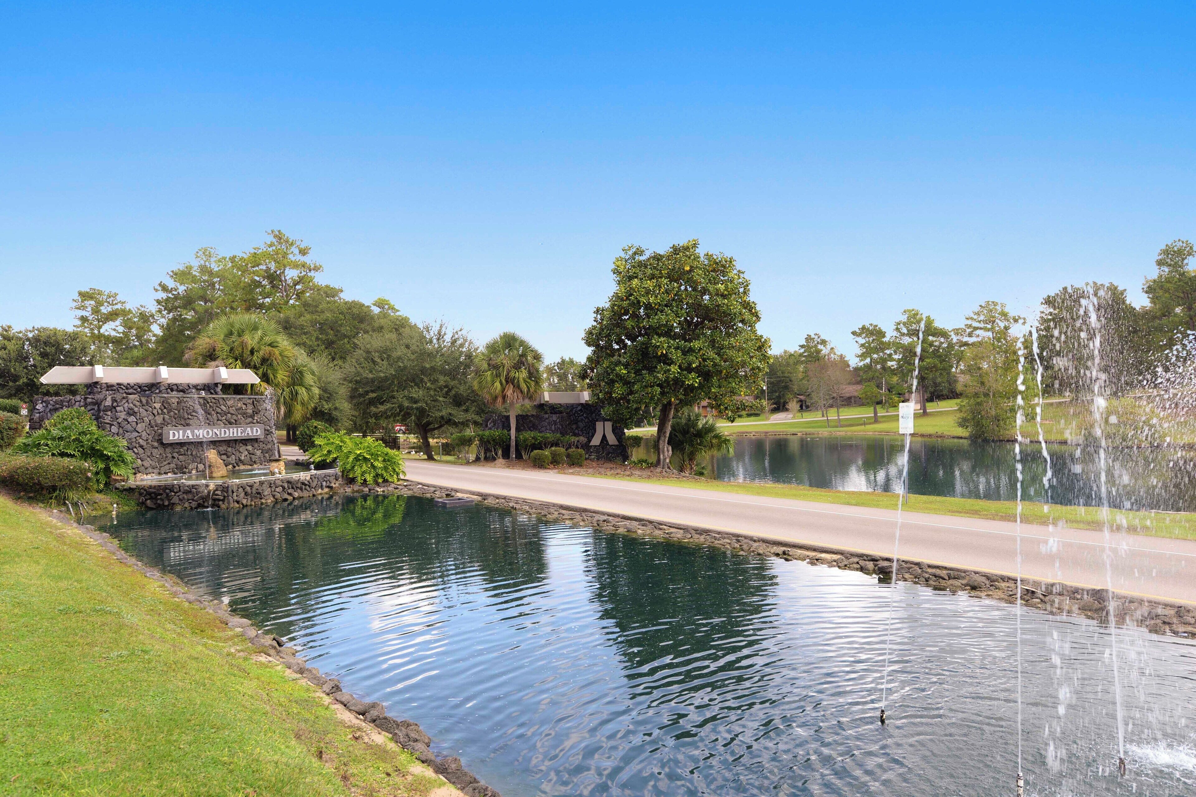 A tranquil water feature with a stone structure labeled 'Diamondhead' and a clear sky.