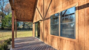 A wooden building with a covered deck and large windows.