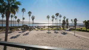 A beach with palm trees and a clear sky.