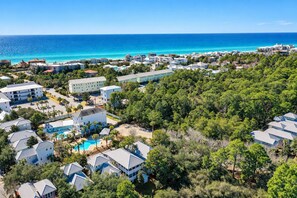 A coastal resort with multiple buildings, a swimming pool, and a view of the ocean. - Good Day Sunshine - 4BR/3BA Old Florida Village Home - Sleeps 8 - Community Pool (Santa Rosa Beach)