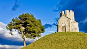 A stone building with a tower on a grassy hill under a clear sky. - Apartment in Privlaka with Terrace, Air condition, WIFI, Washing machine (4839-2) (Privlaka)