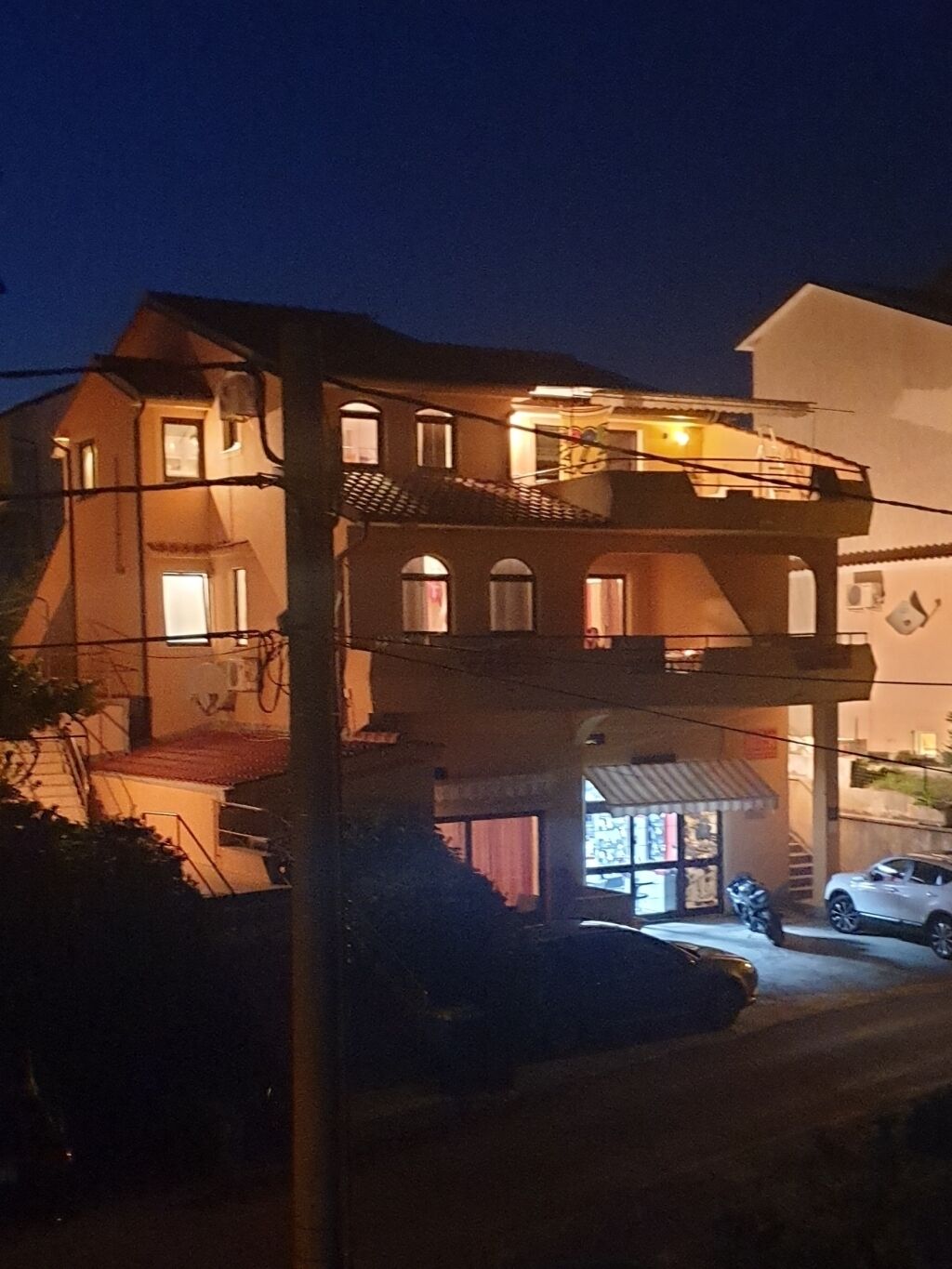 Ein zweistöckiges Gebäude mit einem Balkon im oberen Stockwerk.