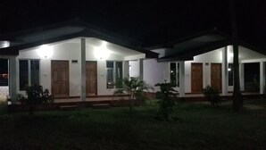 A two-story house with a covered porch and a small garden. - JEYs Place (Nilaveli)