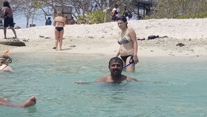 A beach scene with clear water, people swimming, and a sandy shore. - JEYs Place (Nilaveli)
