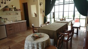 A kitchen with a dining area, a refrigerator, and a window with curtains. - Moshang Caoxun (Changbin)