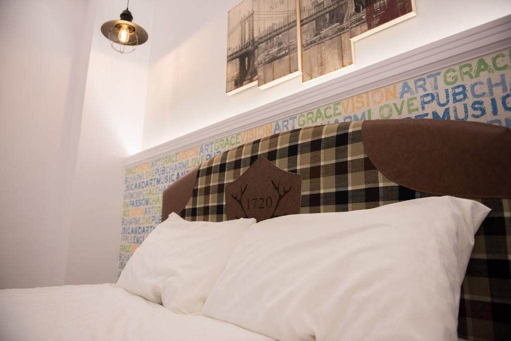 A bed with a headboard featuring a plaque with the year 1720.