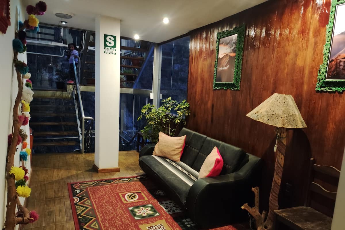 Premier Quadruple Room | Living area | 32-inch Smart TV with cable channels